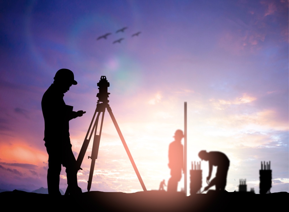 silhouettes-of-land-surveyors-at-work